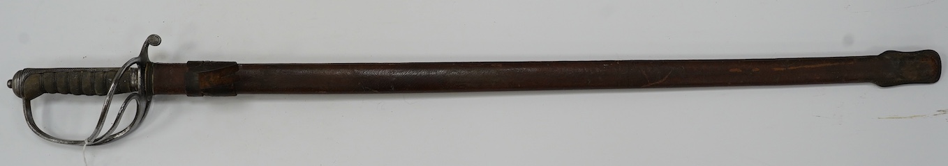 A George V Royal Artillery sword, regulation blade and hilt, in its leather scabbard, blade 90cm. Condition - poor, heavily pitted